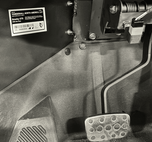 The VIN is visible underneath the driver-side dashboard, left of the foot pedals