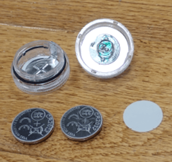 Recalled JINHEZO Mini Waterproof LED Tea Light opened to show accessible button cell batteries