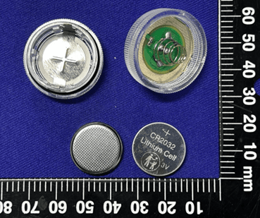 Recalled JINHEZO Mini Waterproof LED Tea Light opened to show accessible button cell batteries