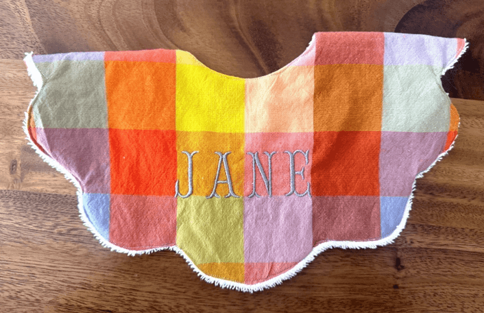 Recalled bib with plaid check print