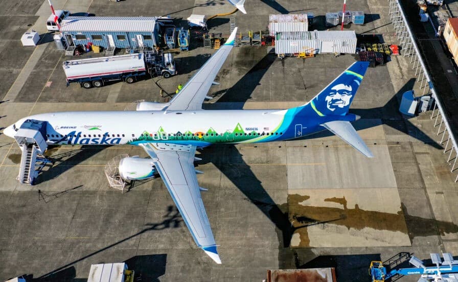 An Alaska Airlines Boeing 737 MAX 9 parked on an airport ramp, viewed from above.