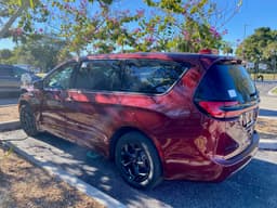 2023 Chrysler Pacifica Hybrid minivan in Velvet Red Pearl Coat, three-quarter front exterior view
