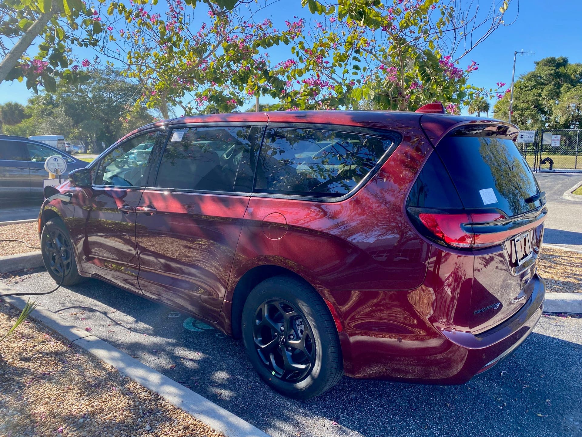 2023 Chrysler Pacifica Hybrid minivan in Velvet Red Pearl Coat, three-quarter front exterior view