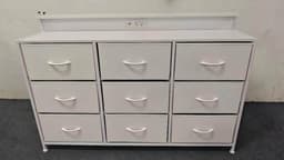 A white DUMOS nine-drawer fabric dresser: nine soft-sided fabric drawers in a three-by-three grid on a metal frame, with a raised back panel holding built-in power outlets.