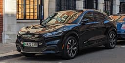 Ford Mustang Mach-E electric crossover, front three-quarter view showing the headlight assembly and front fascia, the subject of the lighting-failure recall