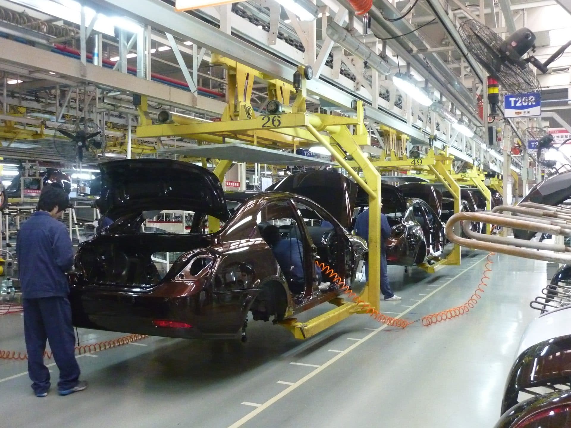 Vehicle bodies on an automotive assembly line at a manufacturing plant — a representative file photo of auto-industry manufacturing, not the Nexteer Automotive facility in Saginaw, Michigan