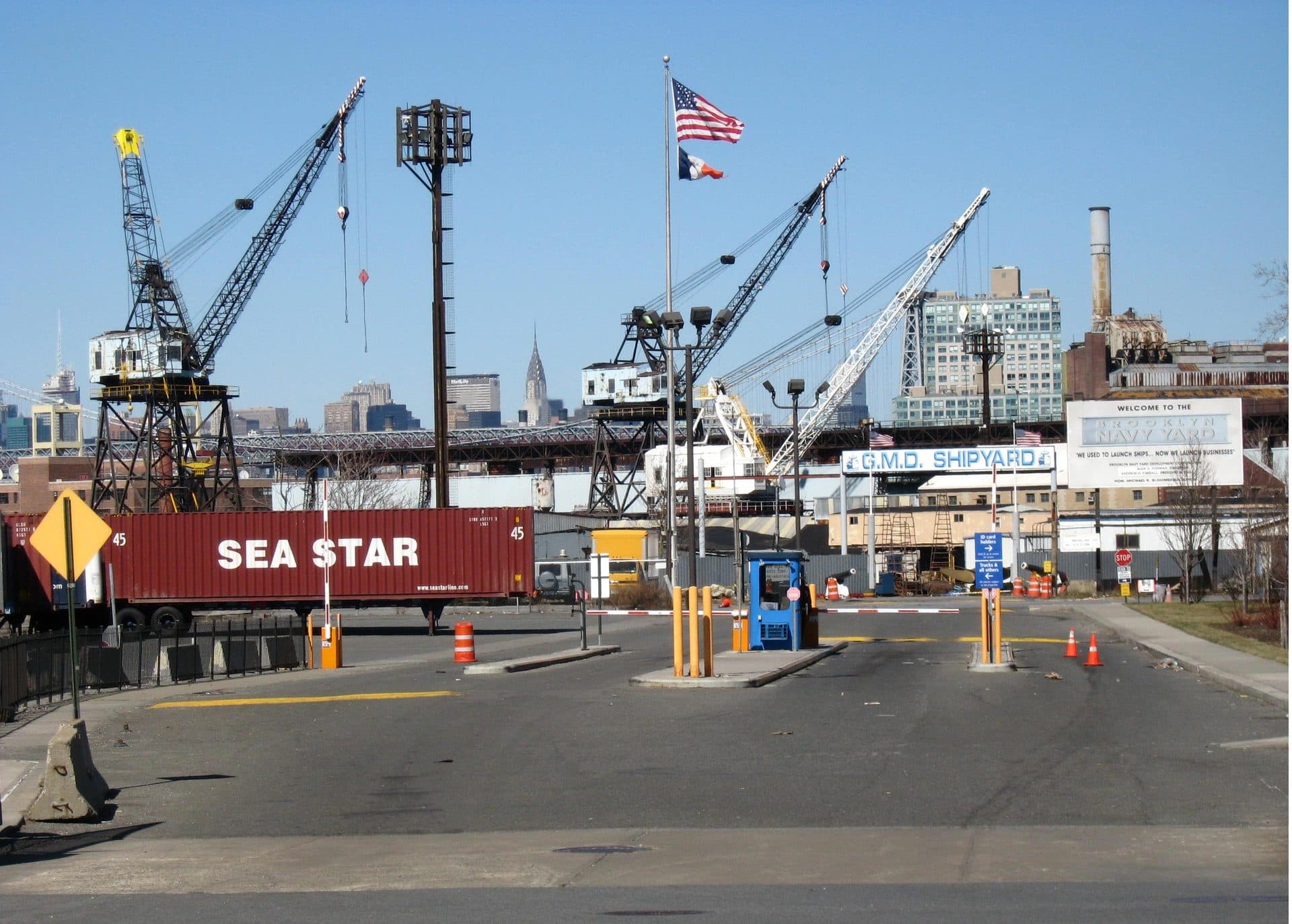 The GMD Shipyard entrance at the Brooklyn Navy Yard, with shipyard cranes and the Manhattan skyline in the background — a representative file photo of a New York City shipyard, not the May Ship Repair facility
