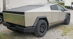 A 2024 Tesla Cybertruck Foundation Series, rear three-quarter view of the stainless-steel exterior — the model line covered by Tesla's recall over a steel wheel and brake-rotor stud defect