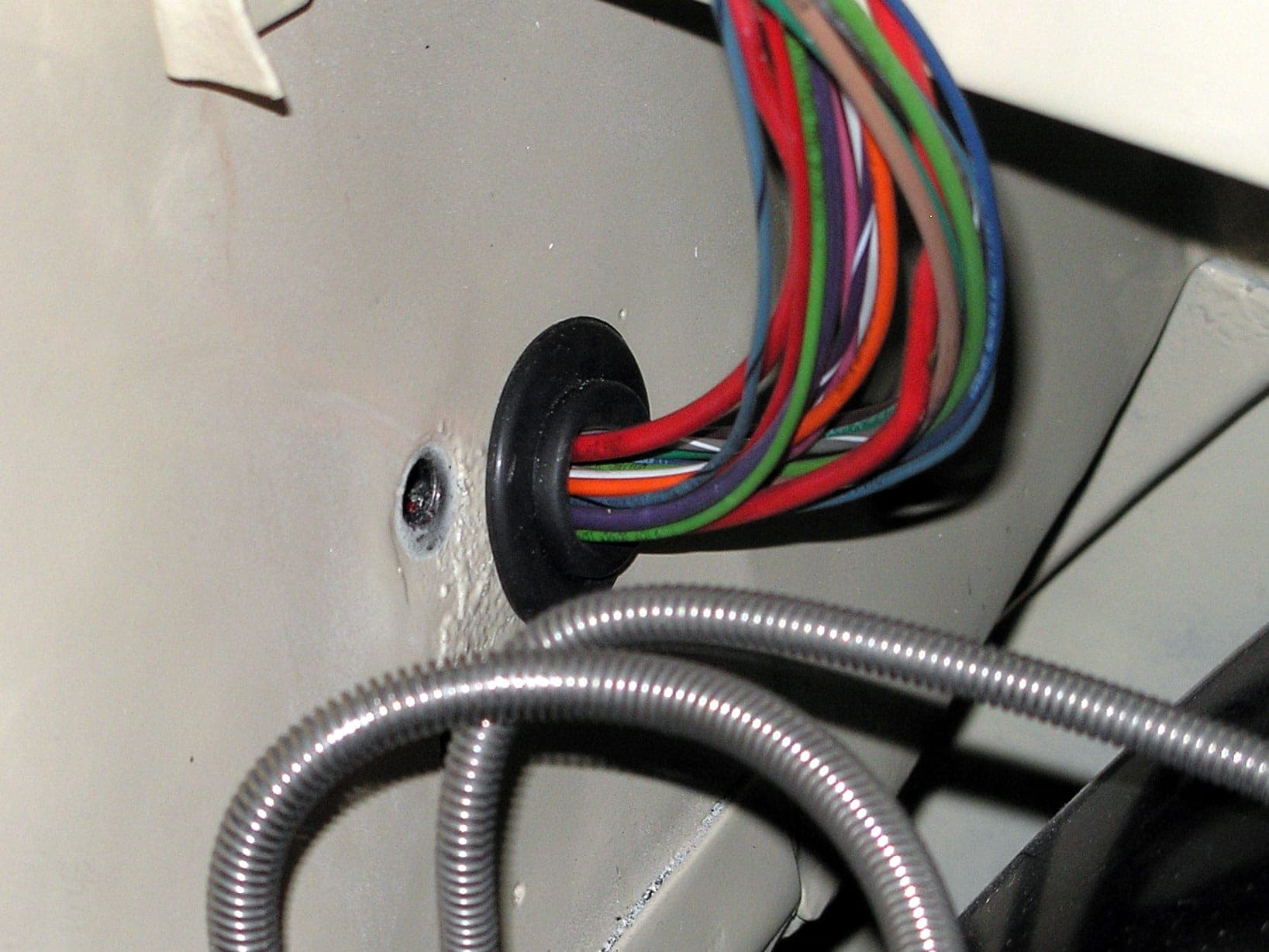 Automotive wiring harness into the engine compartment — representative photo for NHTSA electrical recall